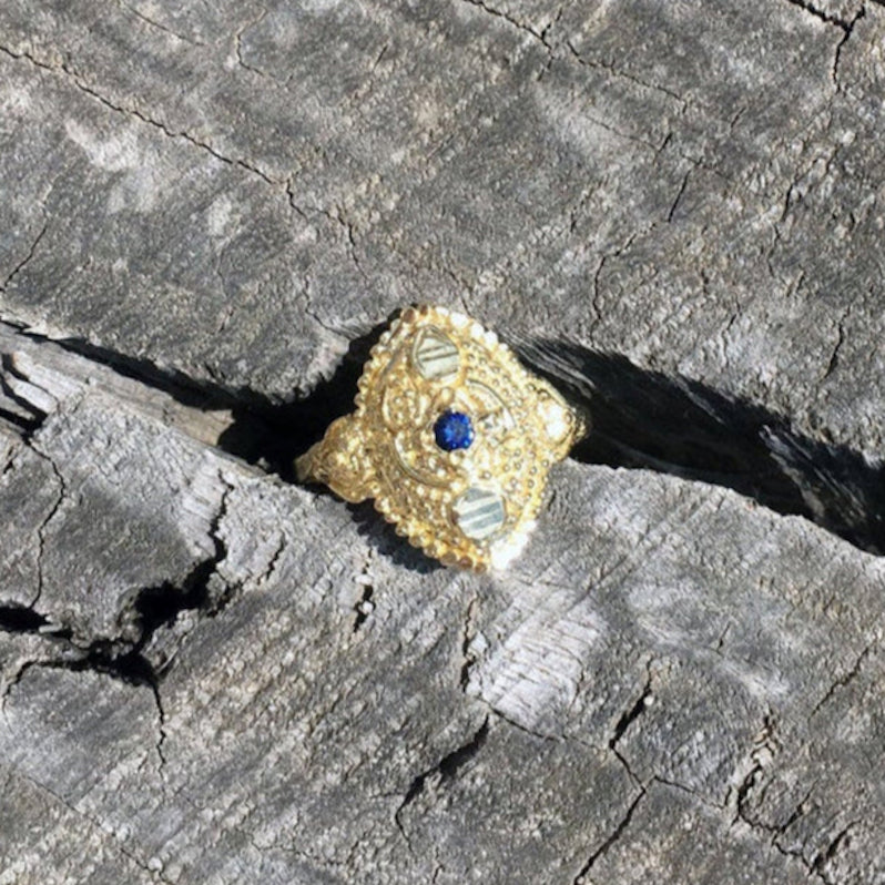 dainty boho chic antique orient style recycled 14 / 18 karat gold ring set with natural blue sapphire. ornament details granulated eye shape gold ring. evil eye protection unique eastern design.