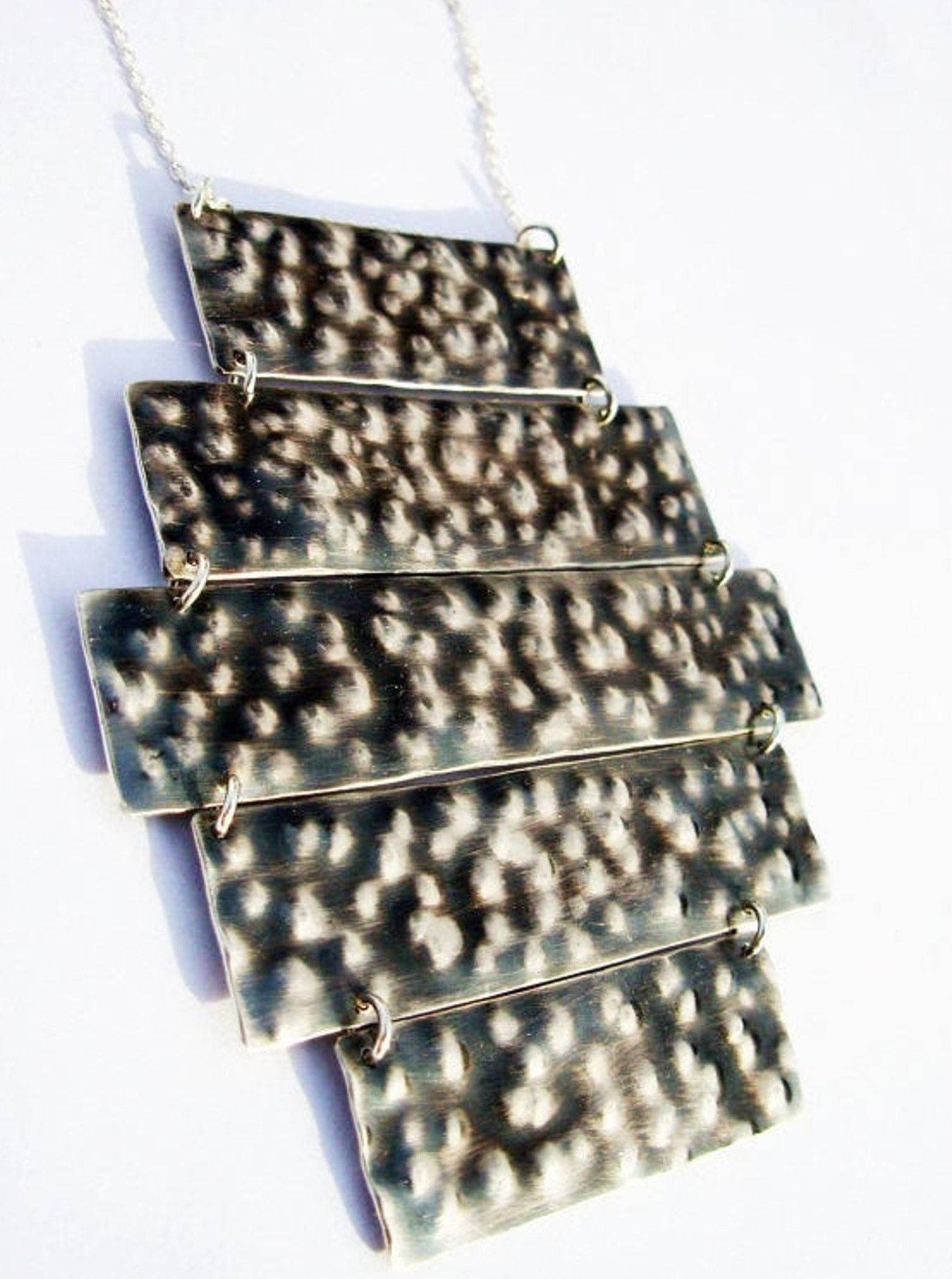 statement large dynamic mobile black silver breastplate with hammered textured bump dots, hand rustic scratches to reveal the metal and and oxidation method. Inspired by the jewish jewelry of the ancient temple.