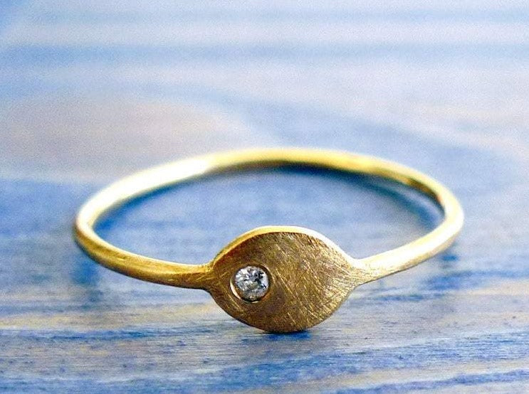 stacking dainty thin alternative ellipse evil eye protection asymmetrical 14 karat solid gold band solitaire set with clear diamond