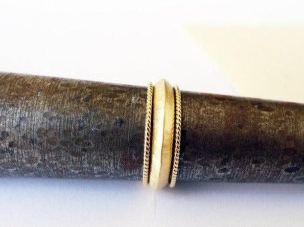 knife edge 14 karat gold ring set with couple skinny braided rings. mix and match vintage style ring set of 3 rings triangle profile center ring and 2 thin twisted rope rings spacers enhancers handmade recycled gold fair trade designer jewelry