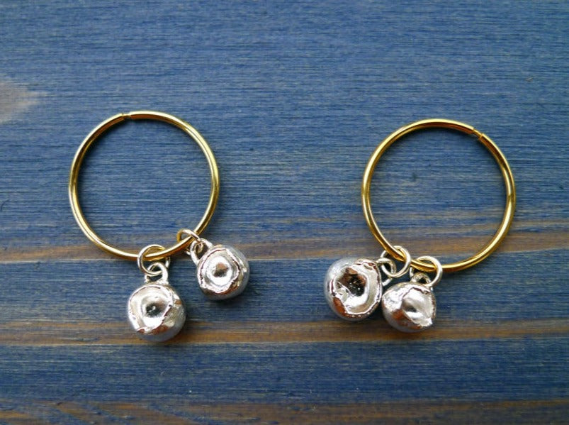 14k gold endless hoops with double trouble gold or silver nugget charms hanged on them with silver loops