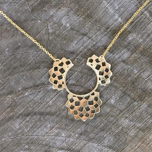 solid 14 karat gold mashrabiya inspired pendant necklace. cutout handmade shields in a half moon arrangement hanged on a thin delicate gold chain