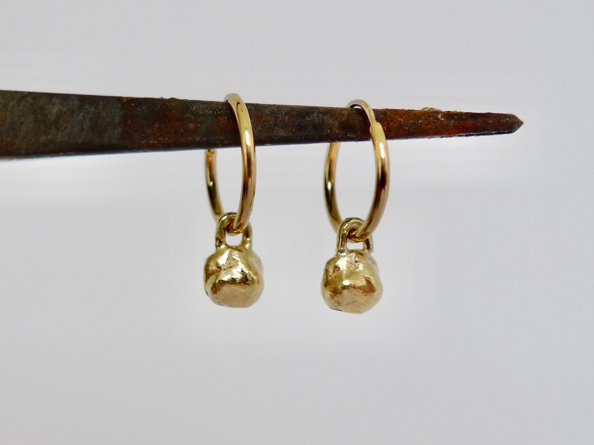 14k and 9k gold hoop dangle organic charms earrings. rustic rugged uneven mini nugget charms on classic endless hoops.