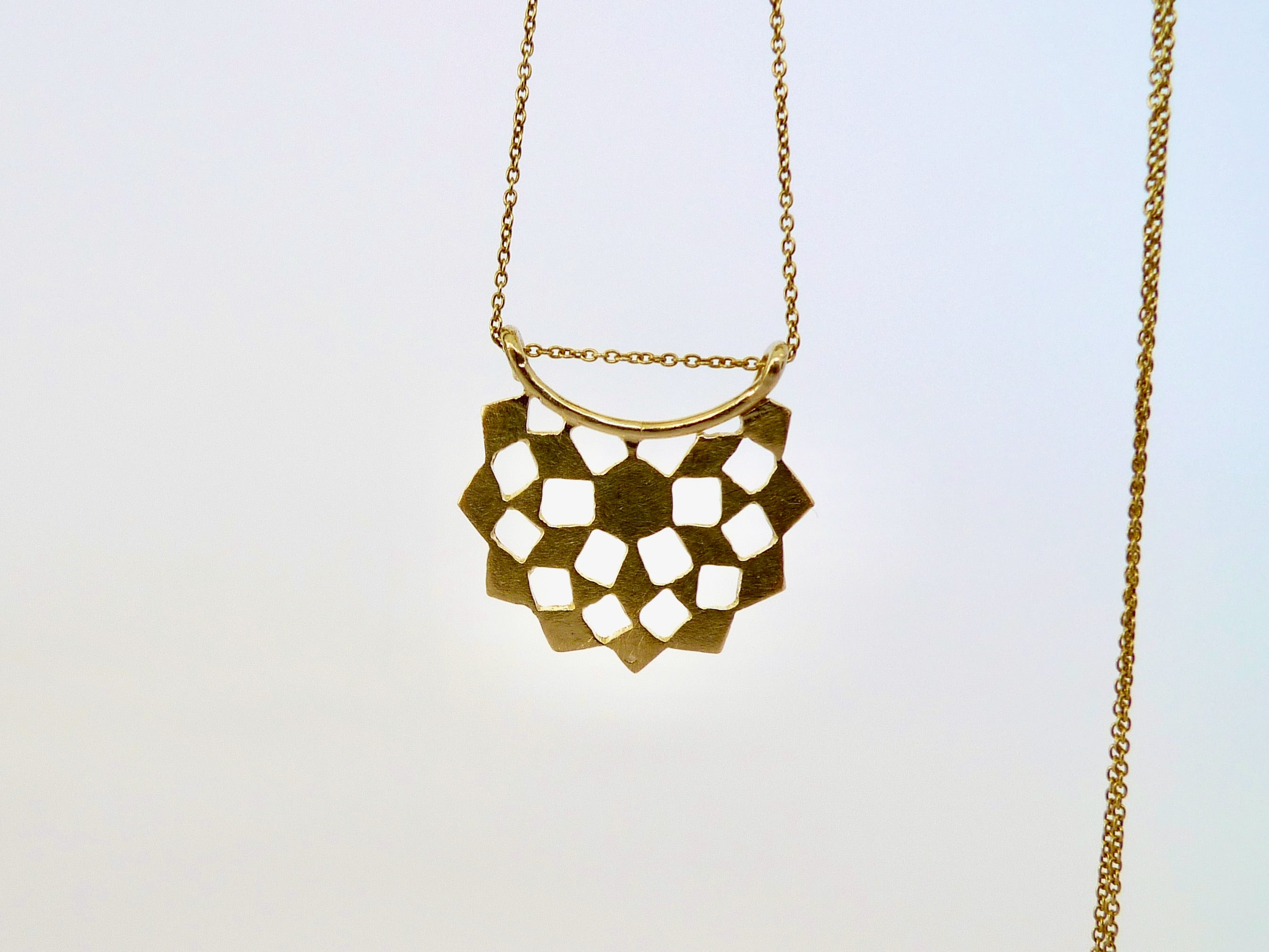 14k Gold geometric pendant necklace on a light gold chain