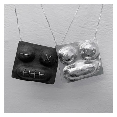 faces pendants puffed handmade necklaces organic tribal stylish runway shiny silver and black dark sewed faces mix match yin yang black white