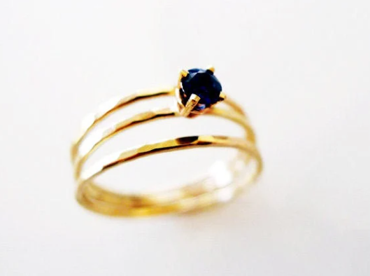 sapphire wire wrap split ring made of 3 slim hammered gold wires soldered at the bottom. recycled 14 karat gold and fair trade brilliant cut sapphire stone. 
