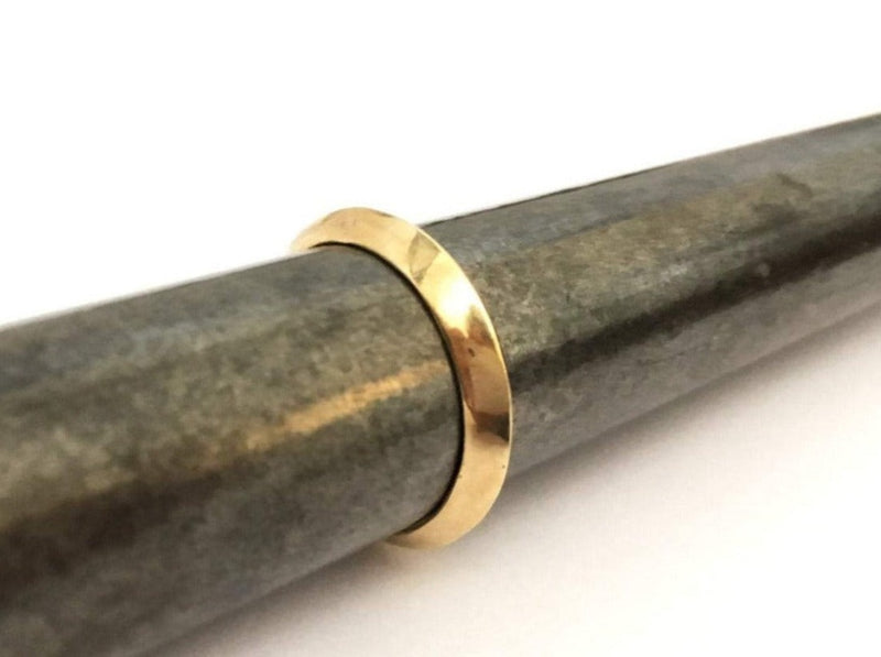 handmade shiny 18 karat gold knife edge shape ring. unisex design man or woman solid gold wedding or proposal ring. Engraveable triangle line band. 