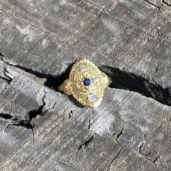 dainty boho chic antique orient style recycled 14 / 18 karat gold ring set with natural blue sapphire. ornament details granulated eye shape gold ring. evil eye protection unique eastern design.