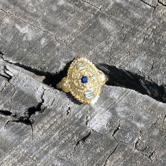 dainty boho chic antique orient style recycled 14 / 18 karat gold ring set with natural blue sapphire. ornament details granulated eye shape gold ring. evil eye protection unique eastern design.