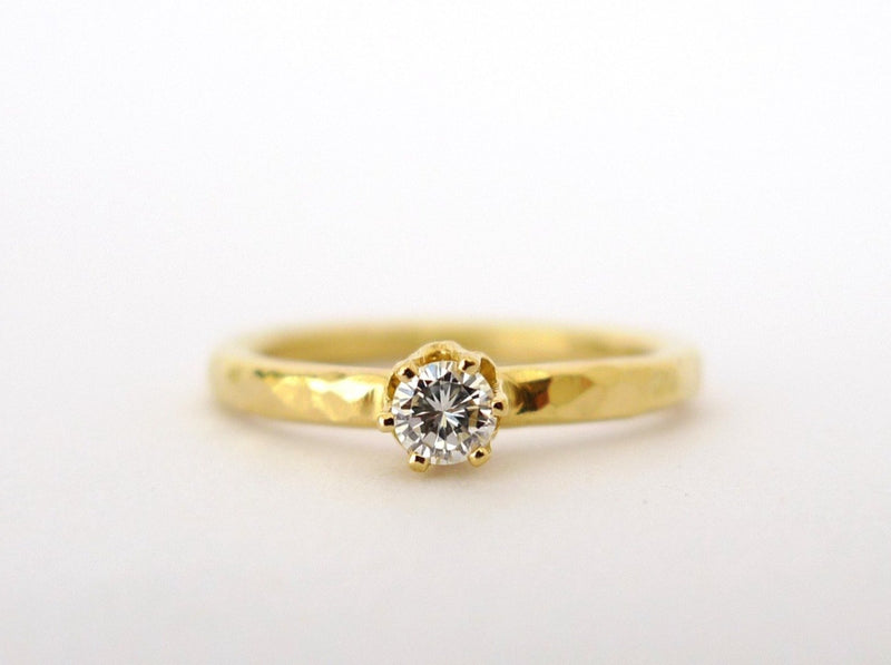 handmade hammered solid 18 karat recycled gold diamond solitaire engagement ring. Brilliant cut 13 points clear diamond set in a vintage style gold ring. rustic wedding style timeless design proposal band