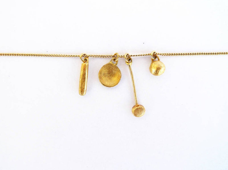 tiny treasures necklace 14 karat gold tiny shapes or tools hanged together on one chain. a set of 4 different rustic small charms to carry on your neck