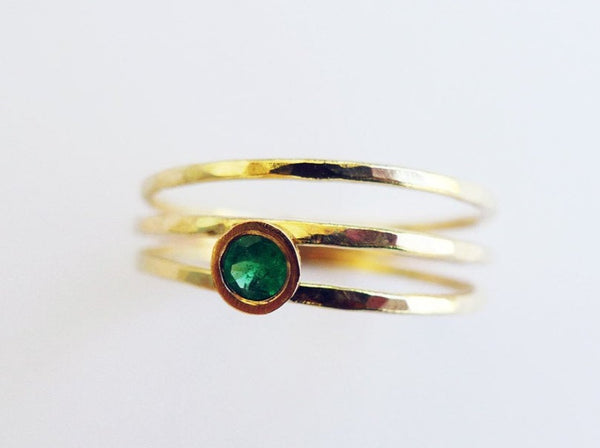gold coil wrap ring hammered 14 karat recycled gold thin split dainty wires set asymmetrically with round brilliant cut emerald conflict free