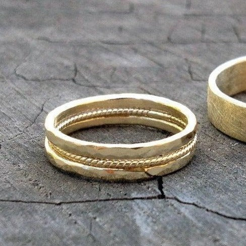handmade 14k or 18k hammered bands with one thin braided twisted rope gold ring in the middle. antique style wedding band set